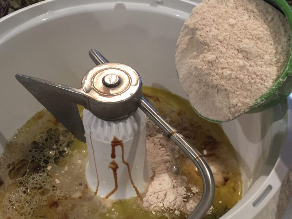Adding flour to liquid ingredients in mixer bowl