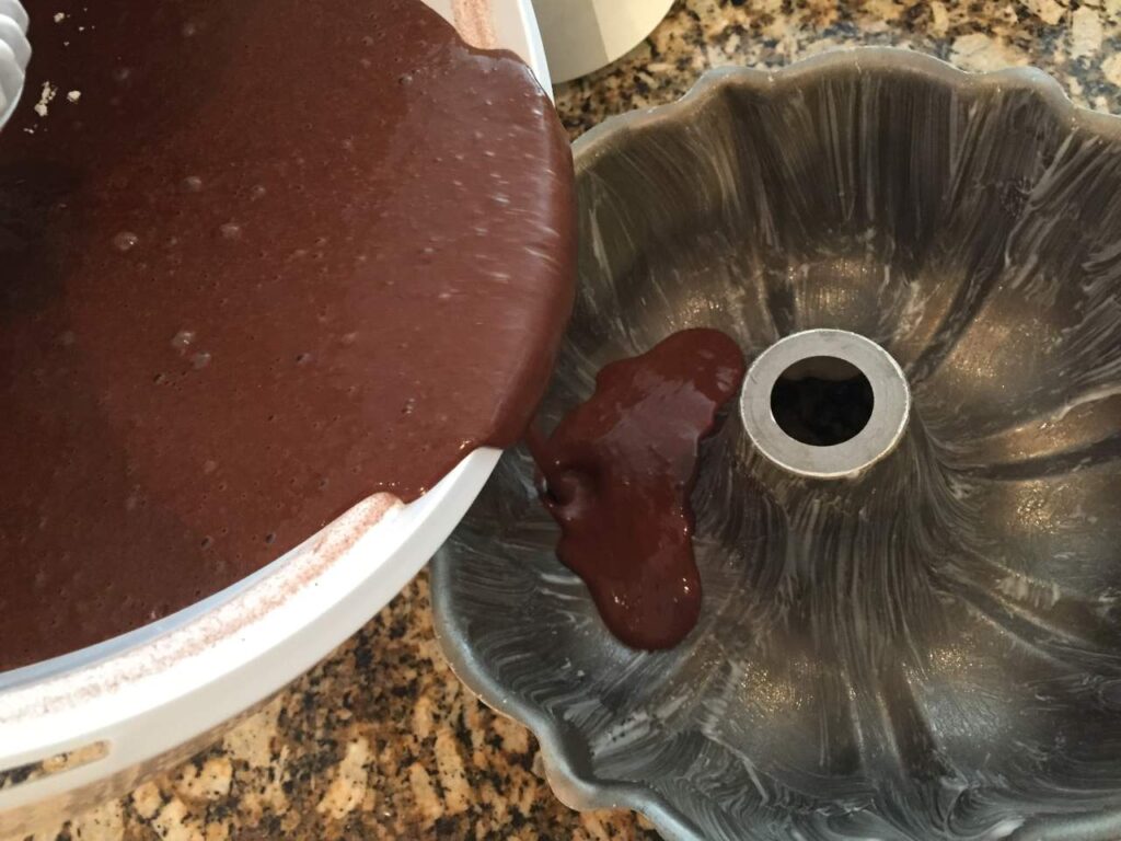 Pouring cake batter into cake pan